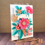 Greeting card dominated by a colorful floral arrangement. The greeting reads Happy Birthday.