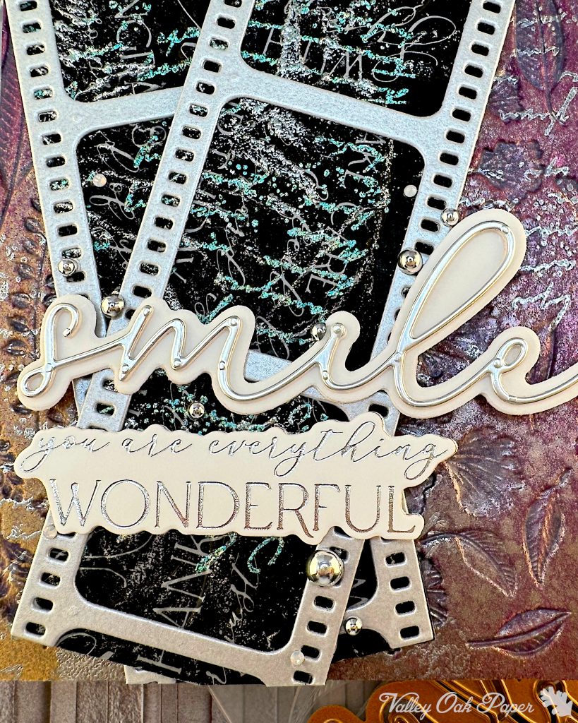 Closeup of the sentiments on a purple and silver greeting card. One sentiment just says "smile," the other one says "You are everything wonderful."