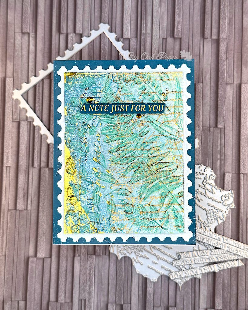 Greeting card in blue and gold tones on a slate grey background. The greeting reads "A note just for you."