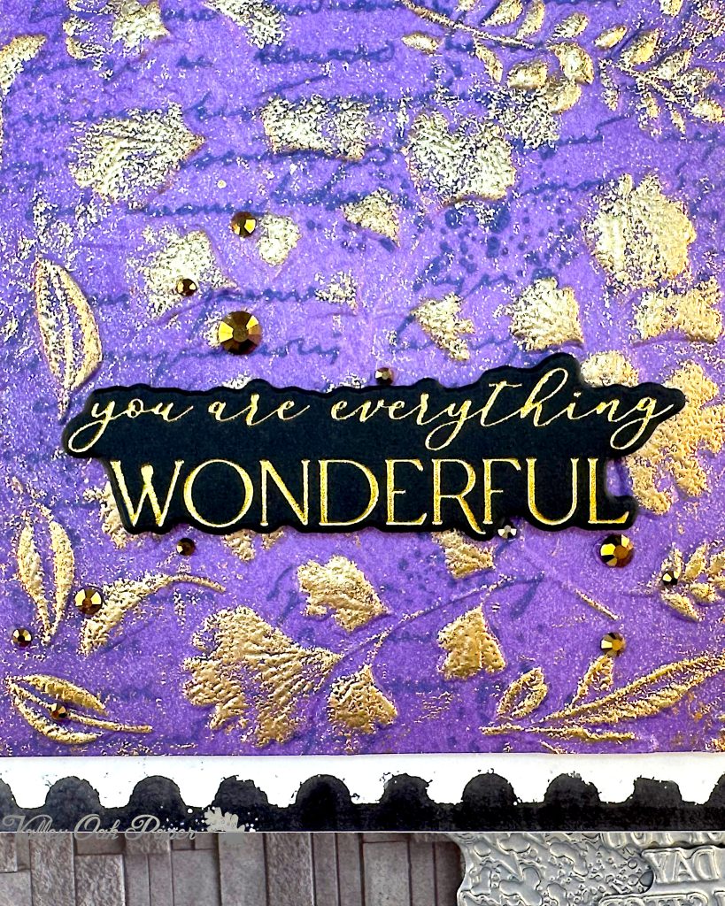 Detail of a greeting card with a purple background. The greeting is foiled in gold on black and reads "You are everything wonderful."