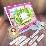 A handmade birthday card with a vibrant purple border featuring a decorative design of colorful paper fruits including strawberries and citrus fruits arranged in a wreath pattern with green leaves. The card displays "Happy Birthday" and "Enjoy Your Special Day" messages in the center. The card is photographed on a wooden surface alongside craft supplies including sentiment strips with phrases like "Happy Birthday," "Thinking of You," "Just a Note to Say," "Thank You," and "Hello Friend." In the bottom left corner is a circular logo for "Creative Influencer Cecilia Huster by Kat Scrappiness." Small decorative strawberry embellishments are scattered around the card.