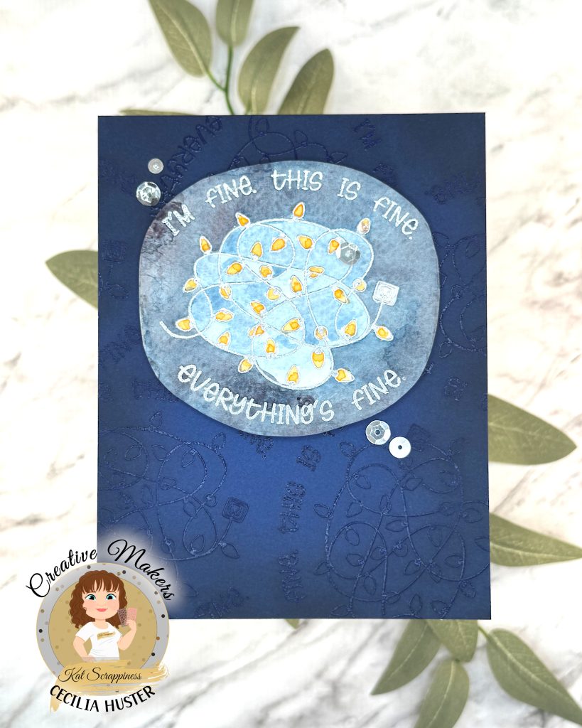 A handmade greeting card with a navy background. The main feature of the card is a watercolor panel showing a tangled light string with lights in amber.
The text around the image says "I'm fine. This is fine. Everything's fine." A few silver sequins adorn the card front.
The card has been photographed on a marble background with salvia leaves. In the lower left corner is a watermark with the text "Creative Maker for Kat Scrappiness: Cecilia Huster."